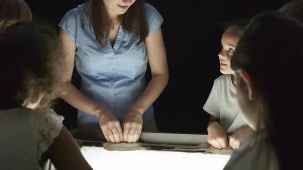 Creative Teacher and Children Making Sand Animation alt
