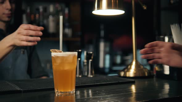 Barman is Decorating Cocktail with Lemon Shaker Bartender Make Lemonade in Restaurant