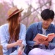 Slow motion romantic moment of young Asian couple reading book together. - VideoHive Item for Sale
