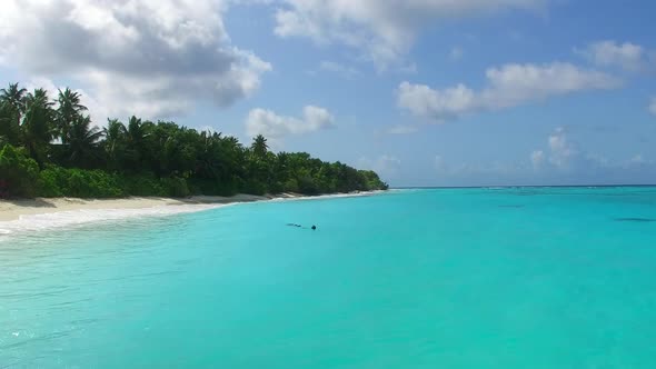 Daytime tourism of island beach trip by blue lagoon with sand background near resort