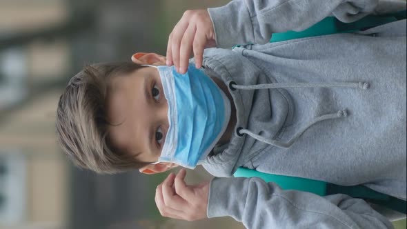 Portrait of a Boy in a Protective Mask on the Street