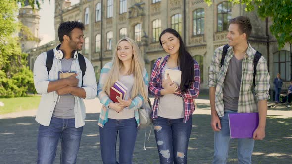 Friends Joyfully Laughing Looking at Each Other, Standing Near University