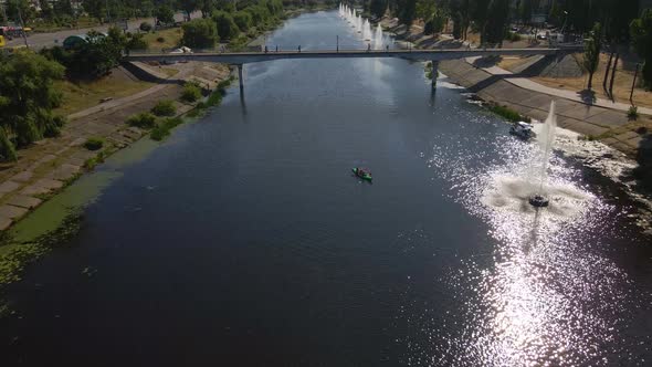 Aerial Footage of a Big Foot Bridge in Kyiv People Crossing the River Dnipro