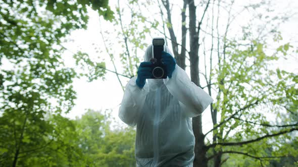 Criminalists Taking Pictures at Crime Scene in Forest Using Professional Photo Camera Taking