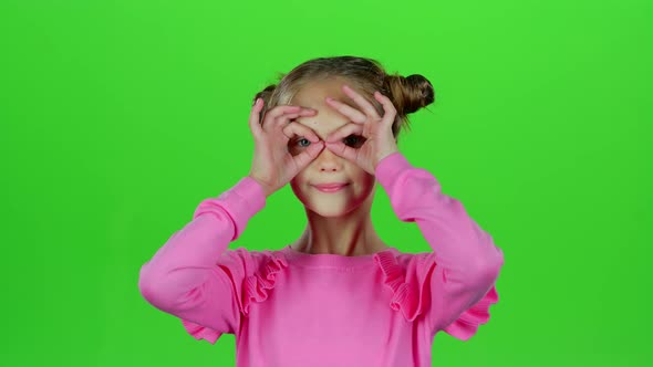 Child Girl Is Making Faces. Green Screen. Slow Motion