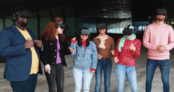Young diverse people wearing virtual glasses outdoor - Metaverse concept
