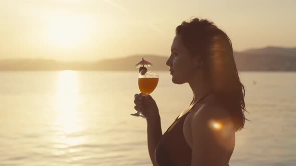 Closeup Video Closeup of a Girl in a Bathing Suit Drinking a Cocktail