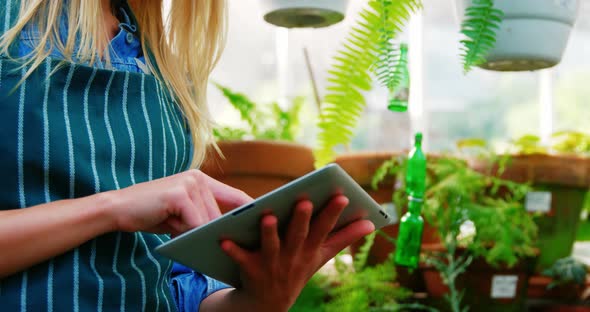 Smiling woman using digital tablet