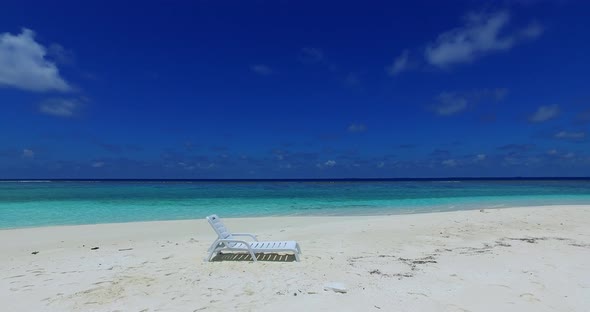 Tropical flying copy space shot of a sunshine white sandy paradise beach and blue water background i