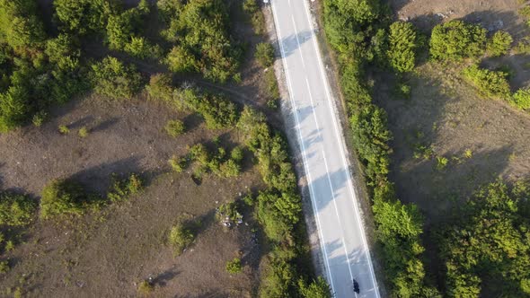 Motorcycle on empty straight road.