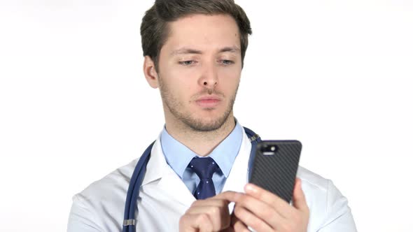 Young Doctor Browsing Smartphone, White Background