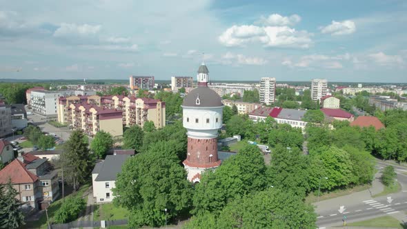 Drone flying backwards revealing Water tower in Elk, built in 1895. Poland