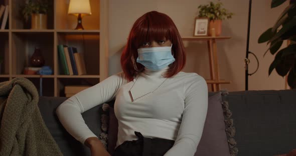 Crop View of Young Woman in Medical Protective Mask Looking to Camera