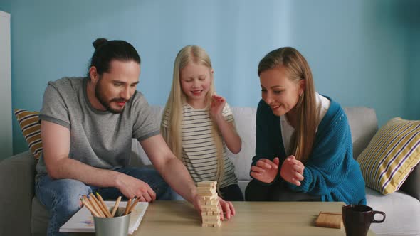 Friendly Family Has Fun Playing Jenga at Home