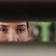 Caucasian woman's eyes looking through panels at factory - VideoHive Item for Sale