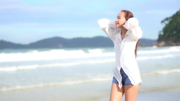 Asian woman enjoy around beautiful beach sea ocean