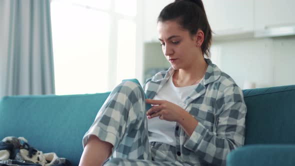 Serious woman looking to the side and texting by phone