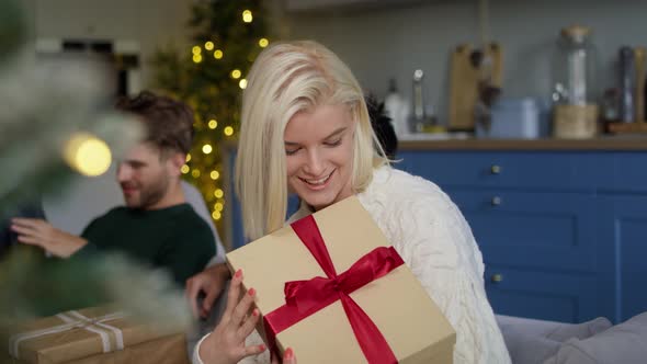 Portrait of cheerful woman with Christmas present. Shot with RED helium camera in 8K