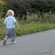 Little boy walking along the road in the park - VideoHive Item for Sale