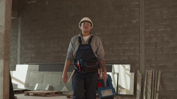 Construction Worker Walking with Toolbox