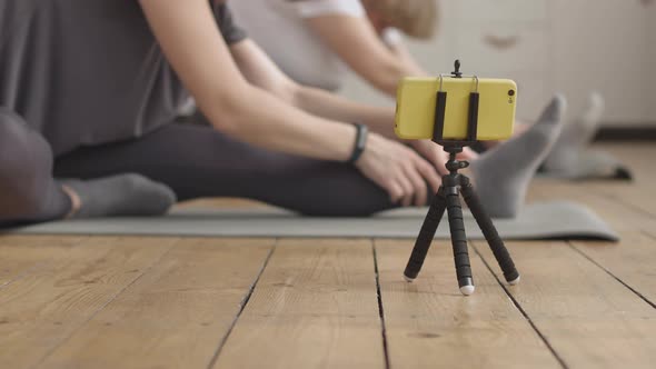 Young Woman Doing her Daily Stretch Routine with her Mother