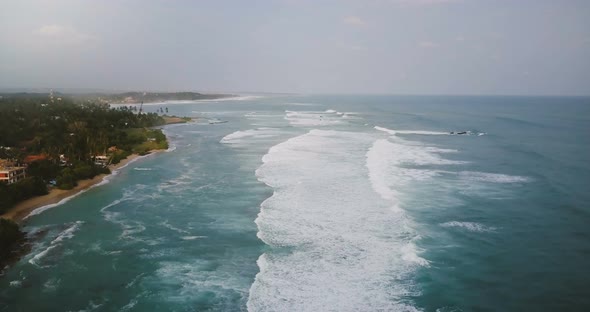 Drone Descending Above Incredible Panoramic View of Exotic Tropical Cloudy Beach, Waves Washing