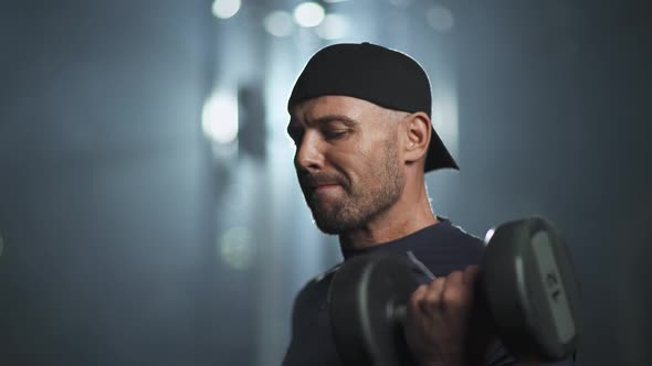 Fortitude Disabled Athlete in Wheelchair Performs Exercises with Dumbbells Gym Training