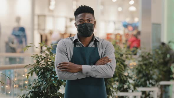 Confident African American Man Wearing Medical Mask Standing Indoors Looking at Camera Young Waiter