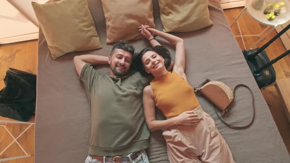 Young Couple Lying on Bed Portrait