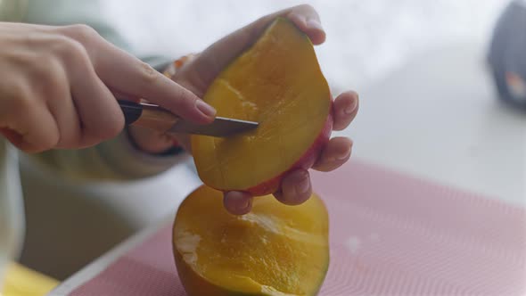 The Woman Cuts and Eats Mango