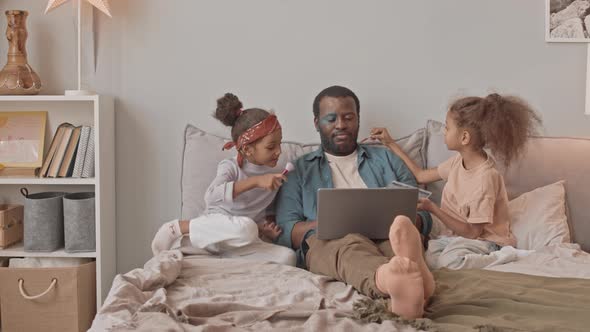 Father of Two Pretty Daughters Working on Laptop from Home