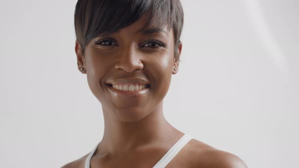 Mixed Race Black Woman in Studio Watching To the Camera and Smiling