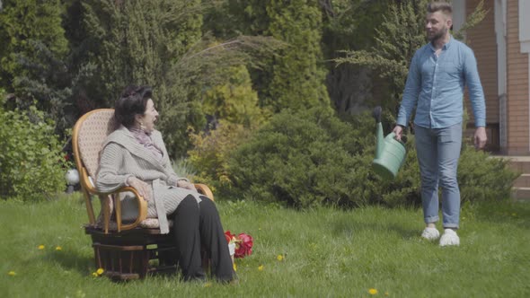 Portrait Mature Lady Sitting on the Lawn in the Rocking Chair Enjoying Sun