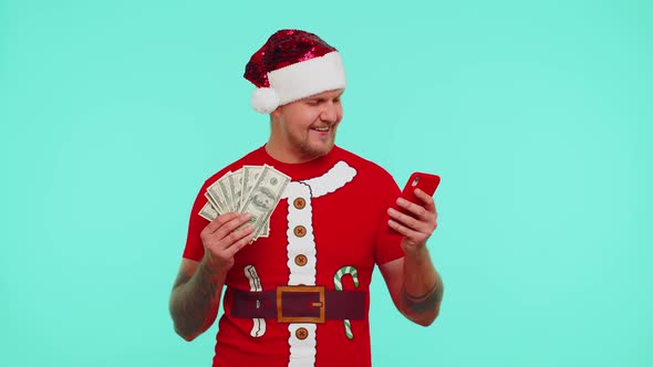 Man in Christmas Tshirt Looking Smartphone Sincerely Rejoicing Win Success Luck Receiving Money