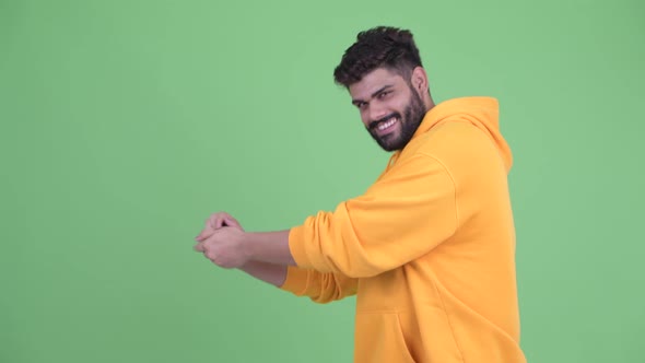 Funny Young Overweight Bearded Indian Man Snapping Fingers and Looking Guilty