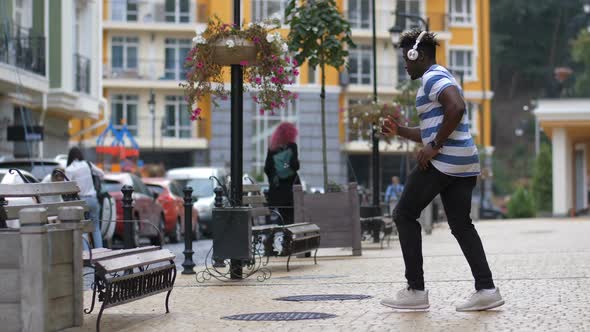 Groovy Man Performing Afrohouse Dance on Street