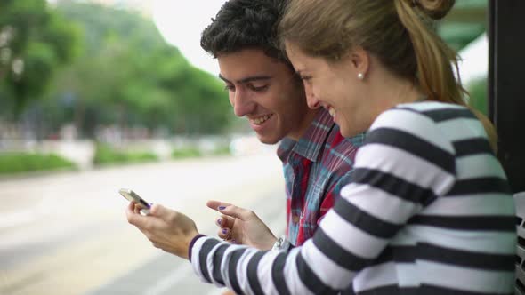 Couple looking at smartphone together