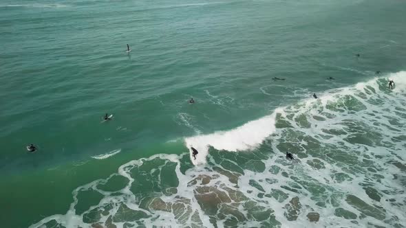 Fistral Beach in Newquay, England - Surfers Having Fun At The Blue Calm Ocean - Drone Shot