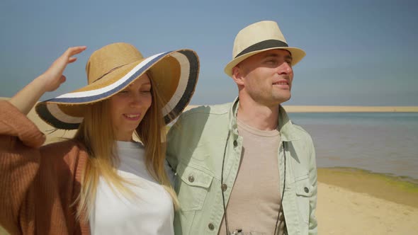 Happy Couple Walking on Beach Together