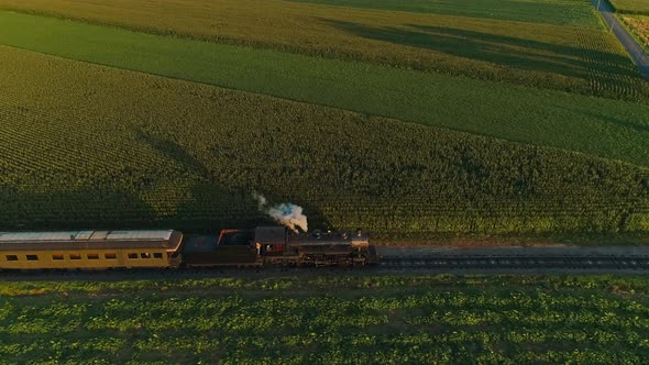 Aerial View of A Steam Passenger Train Approaching Passing Thru a Corn Maze and Corn Fields