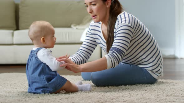 Caucasian Mother Entertaining Baby Girl