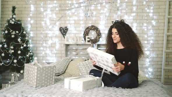 Woman Opening Gift Boxes