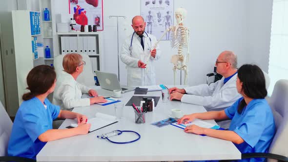 Expert Doctor Analysing Radiography Using Human Skeleton