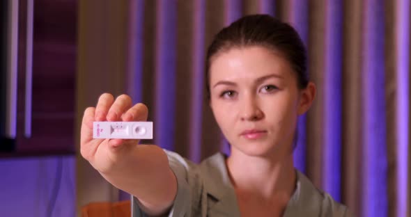 Close up of woman holding rapid test device with a negative result of Covid-19