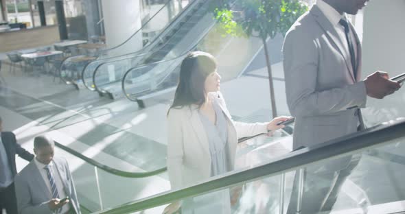 Business people using escalator in a modern office 4k