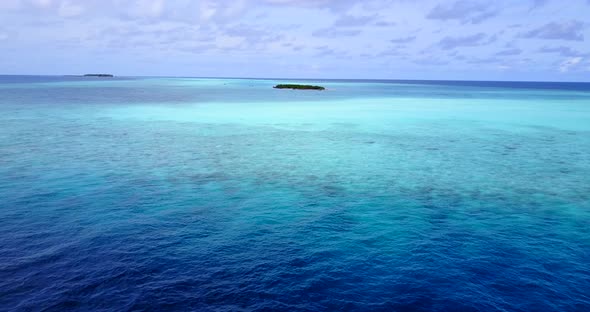 Daytime fly over clean view of a white sandy paradise beach and turquoise sea background