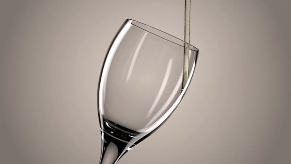 White Wine Is Poured Into The Glass