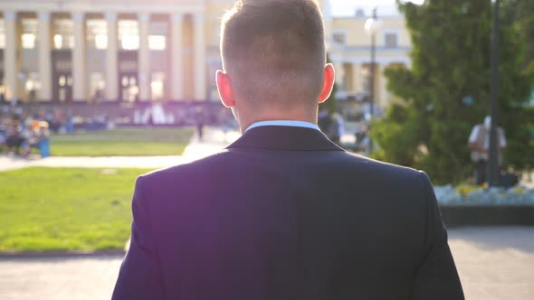 Unrecognizable Businessman Walking at Urban Environment Enjoying Sunny Weather. Man Having Stroll