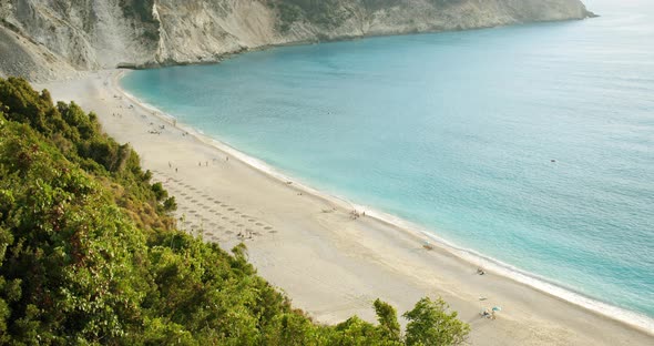 Beautiful Sandy Beach Surrounded By White Rocks and Green Hills with Clean Turquoise Sea Water