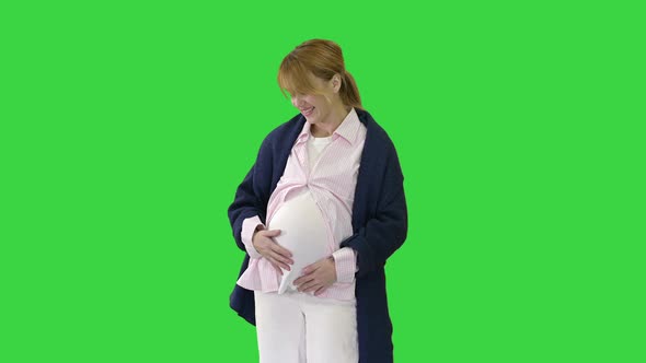 Pregnant Woman Caressing Her Belly on a Green Screen Chroma Key